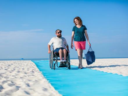 Couple at wheelchair accessible beach access in Gulf Shores