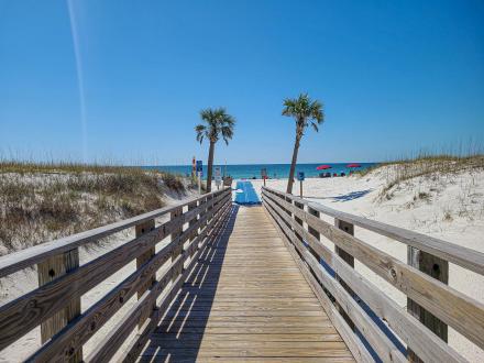 Boardwalk and beach mat at The Pavilion Gulf State Park public beach access in Orange Beach