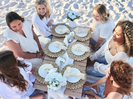 Friends enjoying a cute picnic on the beach in Gulf Shores