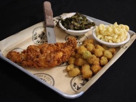 Plate of hot chicken and sides at Luna's southern soul food restaurant in Orange Beach