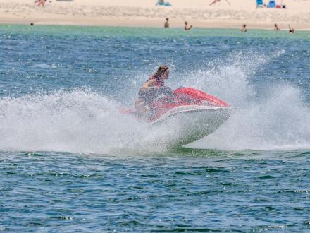 woman jet skiing in the gulf near the shore in orange beach
