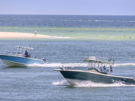 Boats cruising through the water near Perdido Pass in Orange Beach