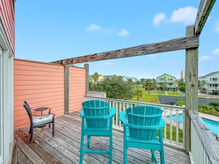 Private outdoor deck overlooking the pool at Schrimsher Beach House vacation home