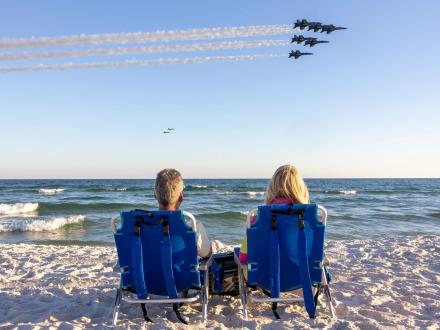 Couple watching Blue Angels soar over the Gulf in Orange Beach