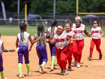 USSSA Softball teams high fiving after a tournament in Orange Beach