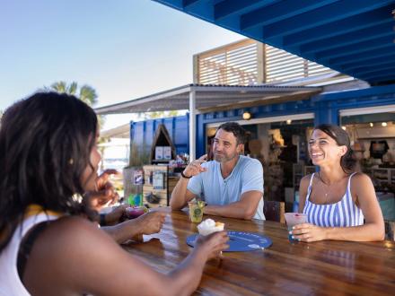 Friends dining at The Gulf beachfront seafood restaurant in Orange Beach