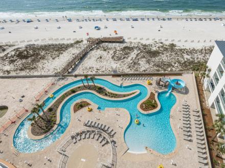 Aerial view of lazy river and pool at Phoenix Gulf Towers condo in Orange Beach