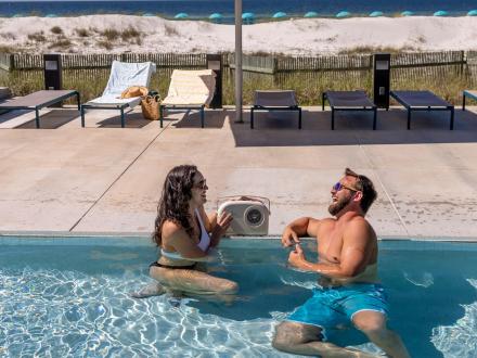 Couple relaxing in the beachfront pool at The Lodge hotel in Gulf State Park