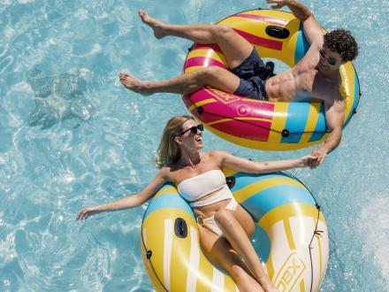 Couple on floats in the pool at their rental