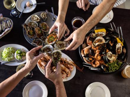 People enjoying oysters at a restaurant