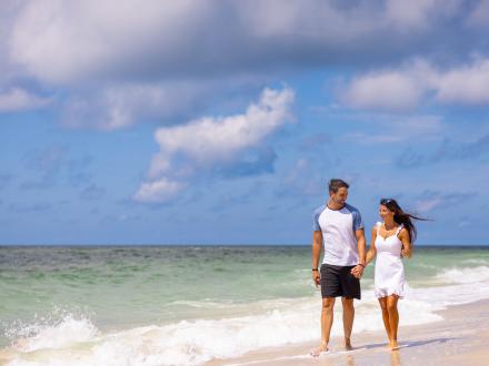 A couple walking hand in hand while strolling Alabama's Beaches