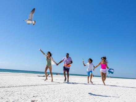 family running on the beach in gulf shores