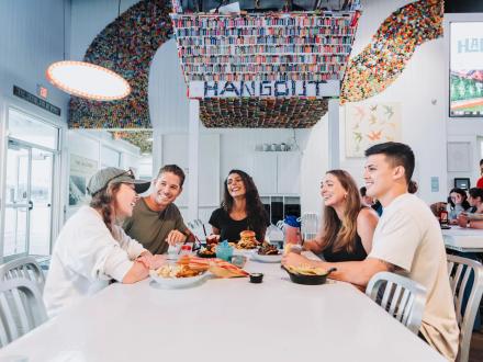 Friends dining at The Hangout beachfront restaurant in Gulf Shores