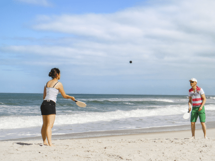 People people paddleball on the beach near the shoreline