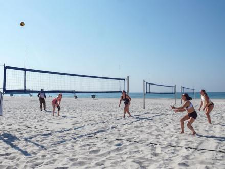 People playing beach volleyball at Gulf Place beach in Gulf Shores