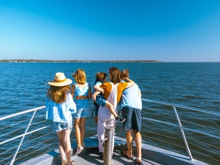 Family looking out into the Gulf on a dolphin cruise in Orange Beach