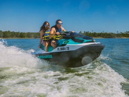 Couple riding a Jet Ski along the back bays of Orange Beach