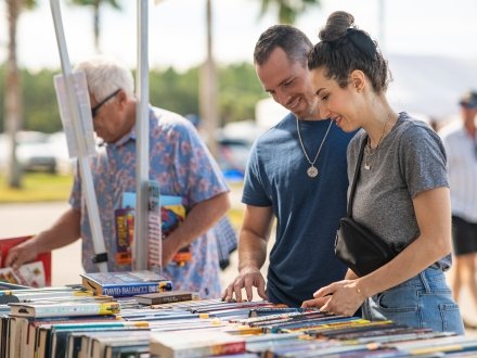 Couple browsing local art from arts and crafts vendors at The Wharf