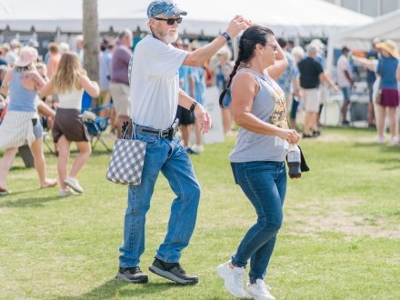Couple dancing to live local music at The Fort Morgan Oyster Fest