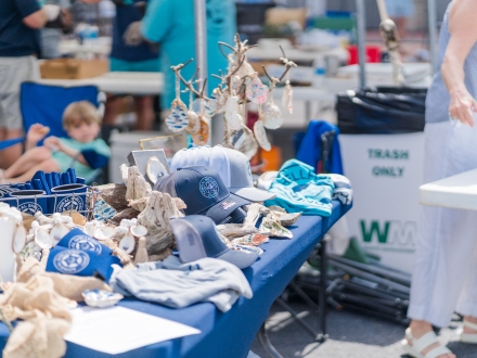 Local arts and crafts vendor booth with handmade coastal goods at Fort Morgan Oyster Fest