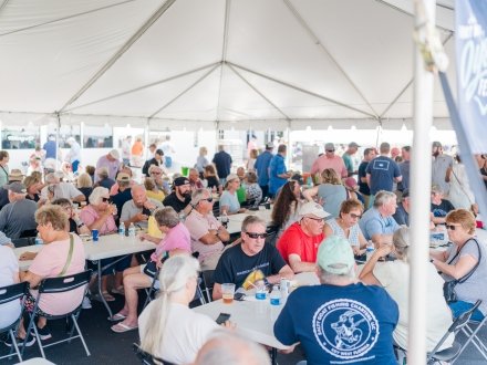 Attendees eating in the food tent at the Fort Morgan Oyster Fest