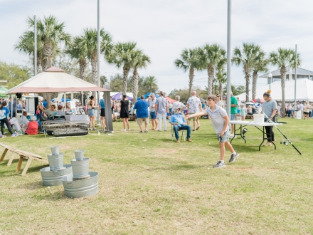 Festival goers competing for prizes in the cornhole tournament at the Fort Morgan Oyster Fest