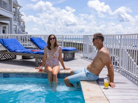 couple relaxing in a private pool at a beach vacation rental in orange beach