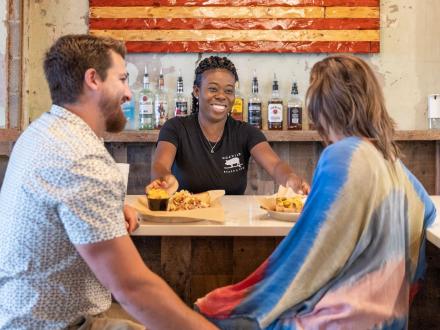 Couple eating barbecue at Hog Wild BBQ restaurants in Gulf Shores