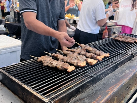 Food vendor grilling fresh meat at Ballyhoo Festival in Gulf Shores
