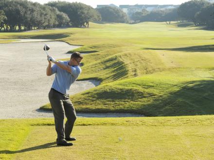 Man golfing at Kiva Dunes