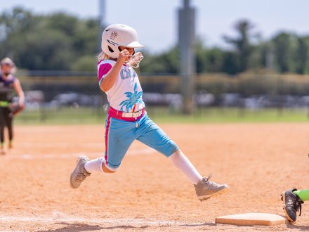 Player running to a base during a softball game on Alabama's Beaches