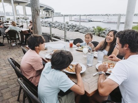 Family dining by the water at Cobalt seafood restaurant in Oragne Beach