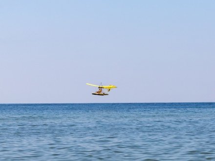 Magni Gyroflight plane flying over the Gulf of Mexico in Gulf Shores