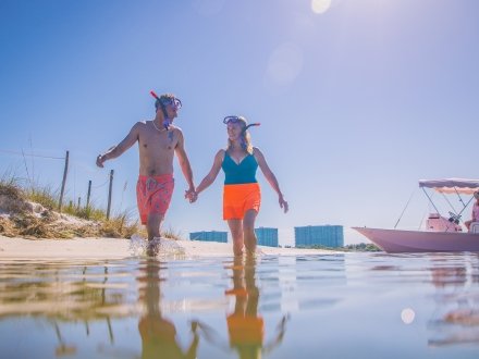 Couple with snorkel masks at Robinson Island in Orange Beach