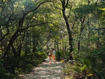 Couple hiking along the Jeff Friend Trail in Bon Secour National Wildlife Refuge in Fort Morgan