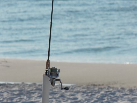 Fishing rod planted in the sand for surf fishing on Alabama's Beaches