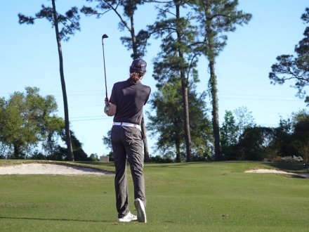 Golfer playing at One Club golf course in Gulf Shores