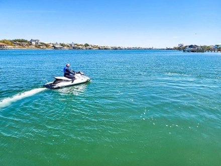 Man riding a jet ski rental from Flora-Bama Marina & Watersports in Orange Beach