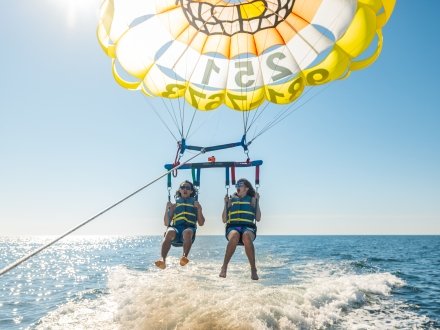 Friends parasailing on Alabama's Beaches
