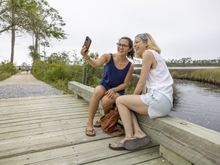 Friends walking on the Pine Beach Trail in Bon Secour