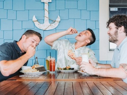 Friends eating fresh seafood at The Beach House Kitchen & Cocktails Gulf Shores seafood restaurant