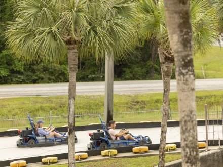 Family racing go-karts at The Track attraction in Gulf Shores
