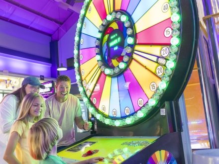 A family playing games at the arcade in Gulf Shores.