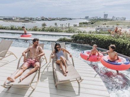 A family enjoying their pool at the Caribe.