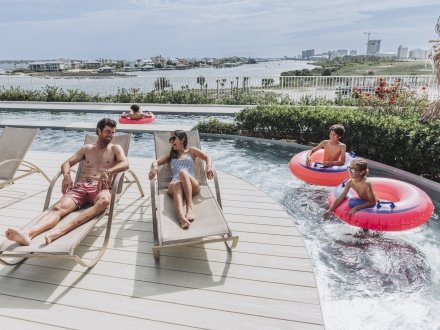 Family enjoying the lazy river at their condo rental on Alabama's Beaches