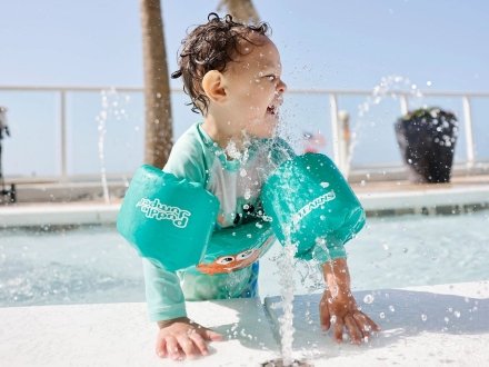 Baby playing in the pool at The Tide beachfront hotel in Orange Beach