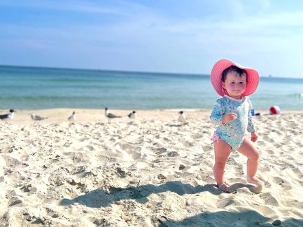 Baby walking by the shore at the beach in Gulf Shores