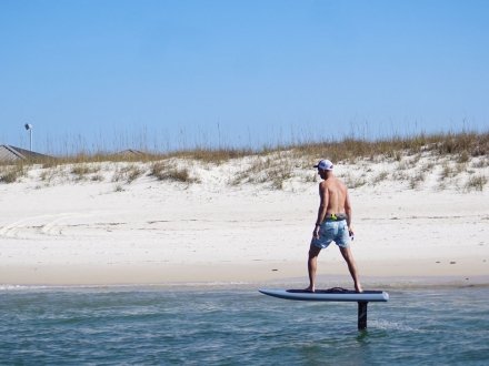 Man riding an efoil board with Foil Gulf Coast in Orange Beach