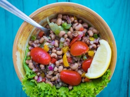 A bowl of Lower Alabama caviar sitting on a turquoise picnic table at LuLu's waterfront restaurant in Gulf Shores