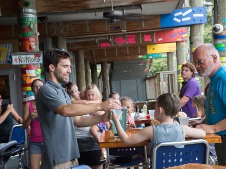 Waiter interacting with a child at Tacky Jacks Gulf Shores family-friendly restaurant